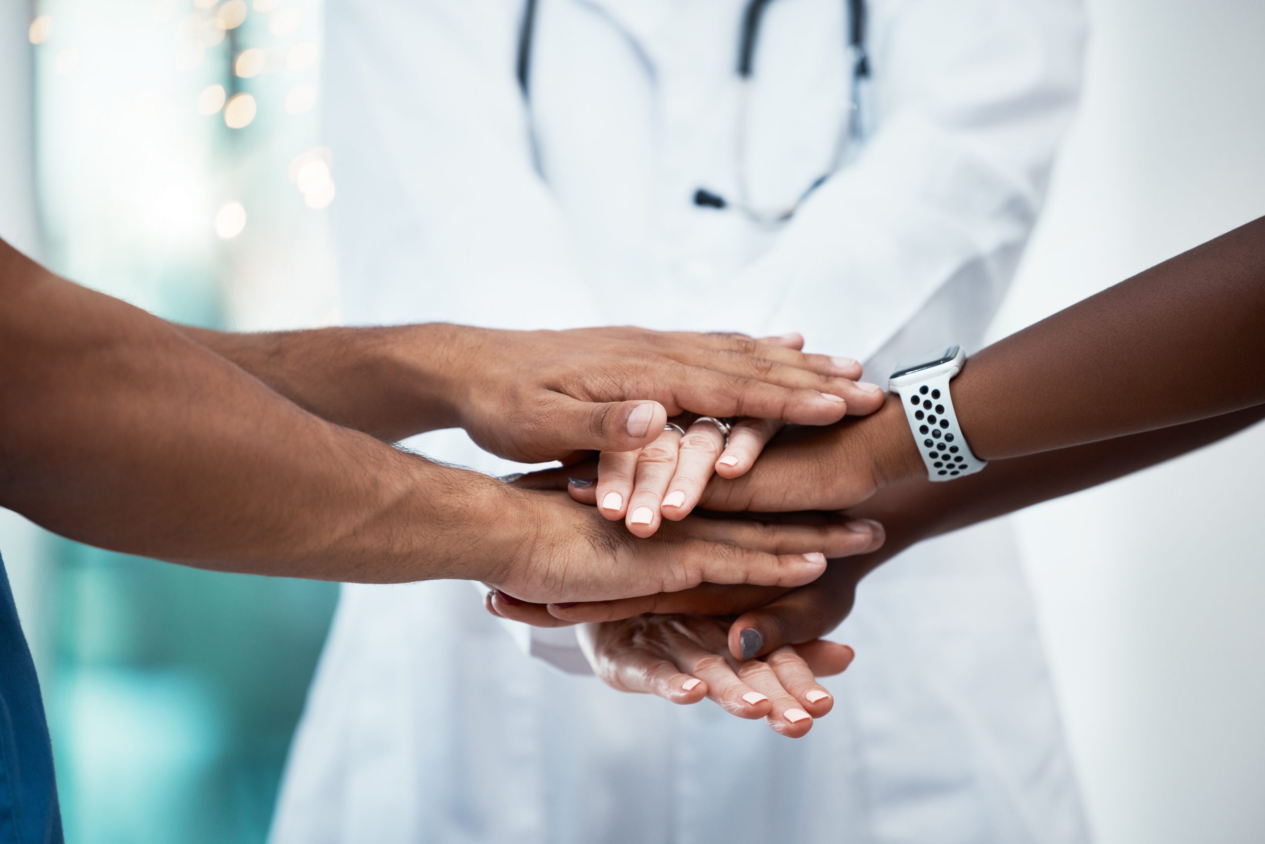 Support, motivation and hands of medical doctor and healthcare workers together for teamwork, trust and collaboration for community health. Women team in solidarity at hospital for partnership goal